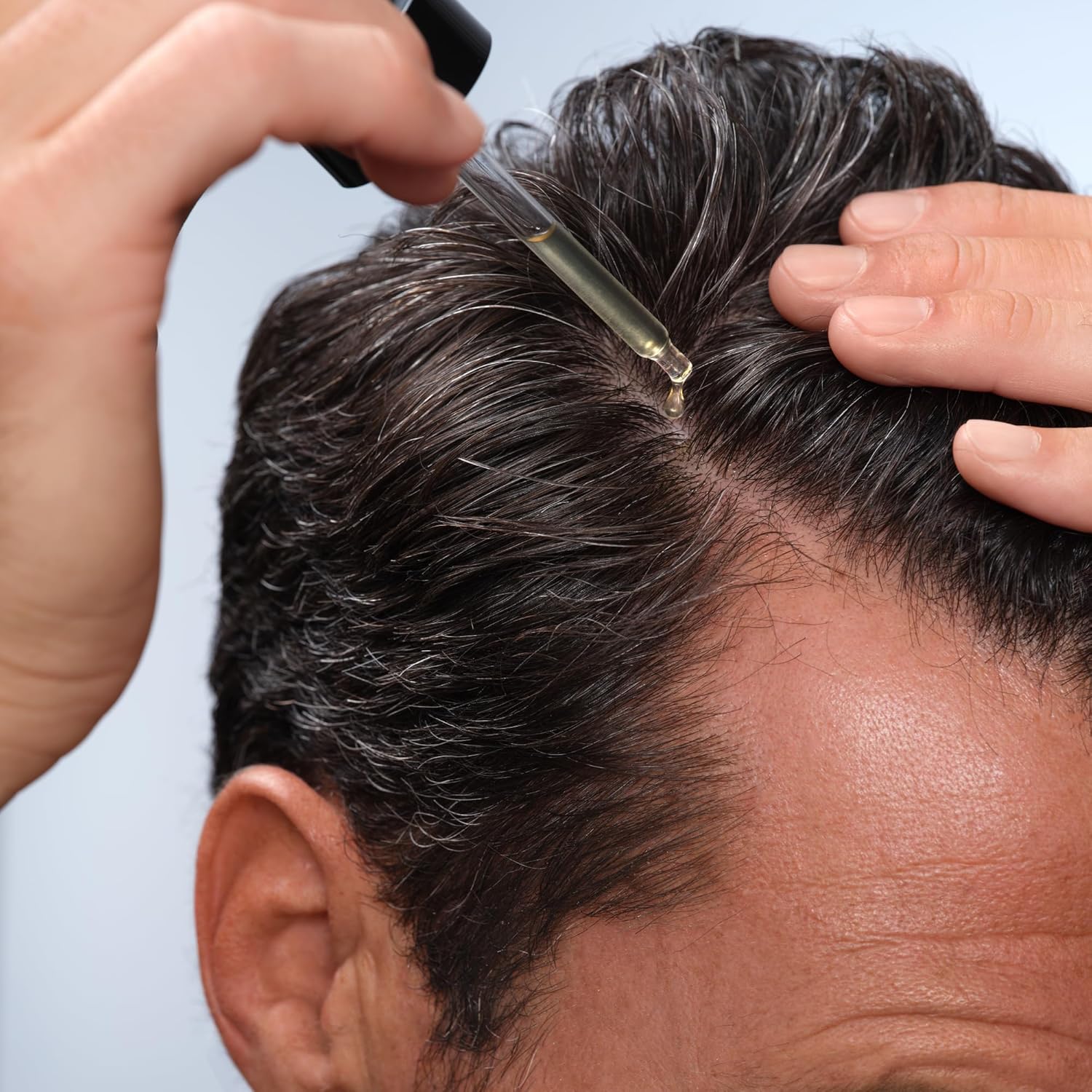Luxury men's grooming lifestyle image showcasing Caldera + Lab The Hair Serum as part of a premium hair care routine.