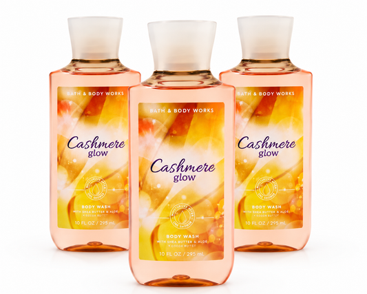 Three Bath & Body Works CASHMERE GLOW Body Wash bottles displayed in a premium catalog-style 3-pack arrangement on a pure white background, showcasing the warm and luxurious CASHMERE GLOW fragrance collection.