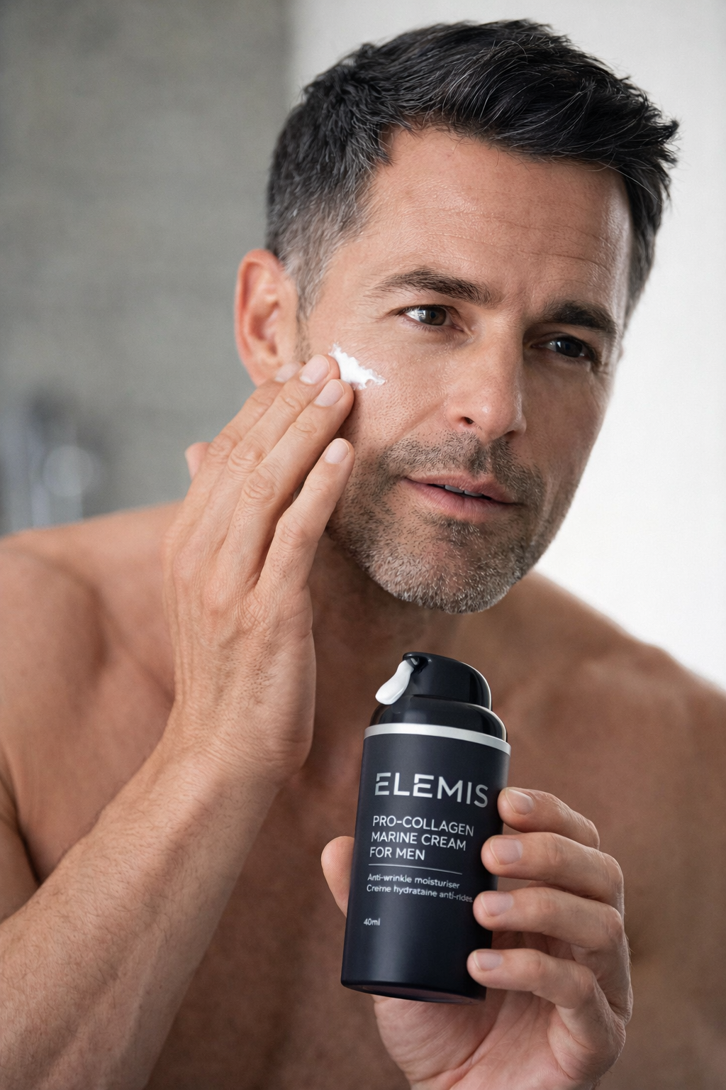 Man applying Elemis Pro-Collagen Marine Cream for Men anti-aging face moisturizer as part of a daily men's skincare routine.