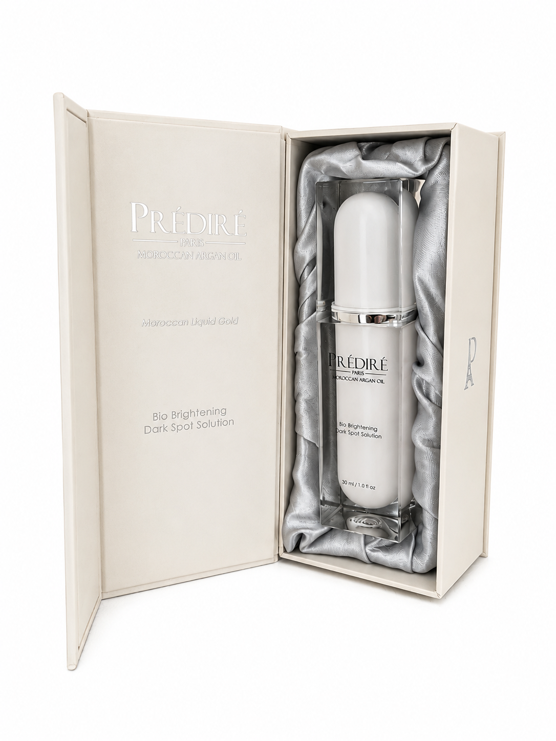 Luxury PRÉDIRÉ PARIS Bio Brightening Dark Spot Solution serum on elegant marble vanity with candle and white roses