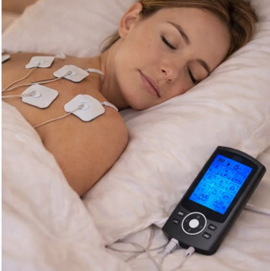 Woman using TENS therapy device for shoulder pain relief and muscle recovery, electric stimulator treatment for tension relief and relaxation at home
