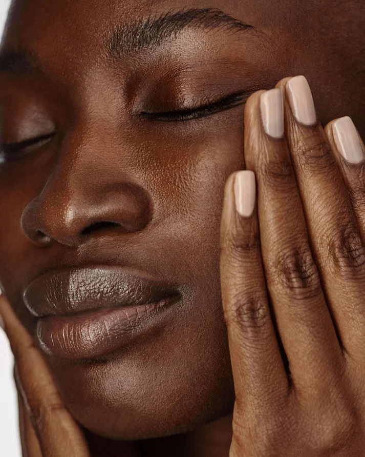 Woman using True Botanicals Phyto Retinol Sleep Serum as part of a luxury nighttime skincare and self care routine for glowing skin